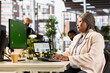 © DC Studio - African american woman review analytics next to isolated chroma key, working hard in the corporate office. Project manager collecting online data for a briefing presentation, firm growth.