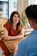 © Peninsula/Stocksy - Beautiful Woman smiling in a restaurant with anonymous man