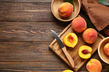 Wall Mural - cutting board and bowls with sweet ripe peaches on wooden background