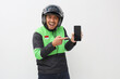 © ArvStd - Asian online taxi driver motorbike wearing green jacket showing blank screen of mobile phone