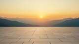 Empty plaza at sunset over mountain range