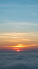 Wall Mural - Time lapse vertical video of dramatic sunrise with fog on a cloudy morning.