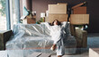 © peopleimages.com - Tired, relax and moving with woman on sofa of new home for property investment, renovation and resting. Relocation fatigue, furniture and real estate burnout with person for exhausted and break