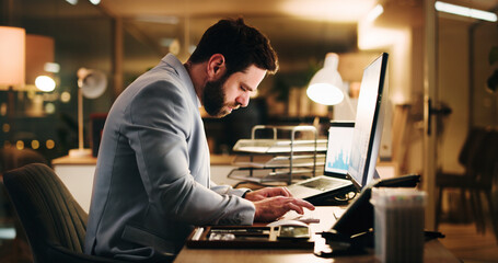 Business, night and man in workplace, computer and internet for stock market, financial agency or email. Evening, typing and person in office, pc and online reading for economy info and connection