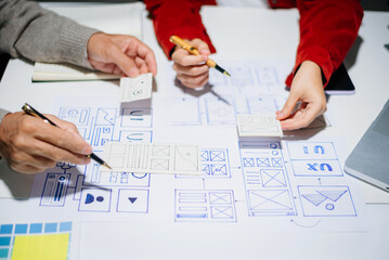 Wall Mural - UX graphic designer planning application process development prototype wireframe for web smart phone. Creative digital development agency.
