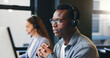 © peopleimages.com - Talking, call center and businessman in office on computer for online advice, help and customer support. Professional, coworking and person with headset for virtual consulting, contact or crm service