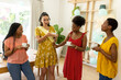© wavebreak3 - African American women enjoying tea and conversation at home, smiling and laughing