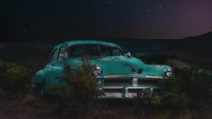 Wall Mural - Cinemagraph of turquoise 1950s US Chrysler car in Utah desert at night with star time lapse