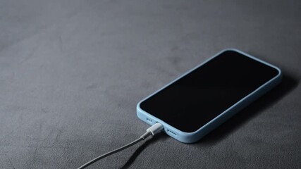 A connected cable charges a dead battery on a smartphone.
Phone charger.
Smartphone, phone, charging, battery