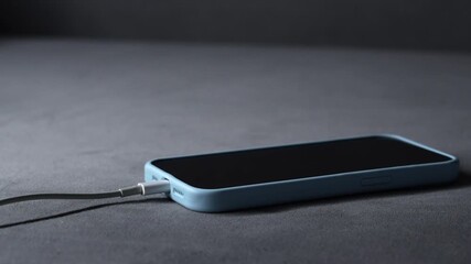 Charging a dead battery on a smartphone.
A switched-off phone is charging.
A charging cable is connected to a smartphone.
A modern smartphone is charging.