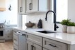© Abian rasyid - Modern kitchen countertop and cabinets in a light gray color scheme.