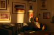 © Francis - Man relaxing on a sofa with headphones in warm evening light. The cozy living room is decorated with framed artwork on the walls.