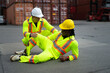 © Suney - Blue collar worker is take care injury co worker at container warehouse.