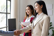 © Wasan - Businesswoman shaking hands with colleague after meeting in office. Business people shaking hands in the office for a deal, collaboration. Employees with handshake for welcome or greeting.