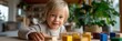 © Iryna - Blonde caucasian child engaged in colorful wooden blocks play at home