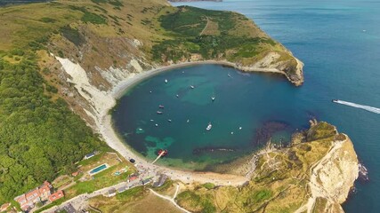 Wall Mural - Descending orbital drone footage of the famous Lulworth Cove in Dorset, England