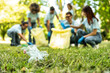 © Davide Angelini - Group of volunteer cleaning picking up plastic litter in the park - Diverse group of people collect trash in the forest - Environmental protection, non profits organization and save the planet concept