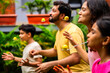 © StockImageFactory - Fun outdoor lemon spoon race with Indian family bonding in home garden during weekend playtime