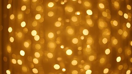Wall Mural - Abstract golden bokeh shimmering lights creating a dense, sparkling curtain effect, a seamless and luxurious video loop texture, celebration, glow