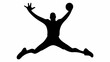 © Hala - Silhouette of a man jumping with legs spread and holding a ball in one hand with the other raised
