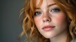 © jarmhan - Close-up portrait of a redhead with freckles against a neutral backdrop