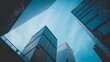 © Kazi - Low angle view of several modern skyscrapers with glass facades against a clear and beautiful blue sky.