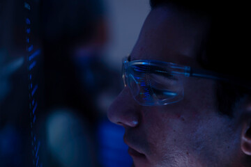 Two software developers collaborating at night, focusing on code review and debugging process on a computer screen, representing teamwork, innovation, and modern software development workflow.