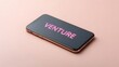 © FocusFusion - Smartphone Displaying the Word Venture on the Screen