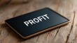 © FocusFusion - Profit Displayed on a Tablet Resting on a Wooden Table