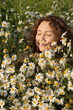 © Liliya Rodnikova/Stocksy - Portrait of calm relaxed and happy woman in daisies