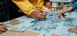 © InfiniteFlow - A vibrant collaborative design session showcasing diverse hands engaged in creating architectural blueprints and models, highlighting teamwork and creativity in a bright workspace. SACTR