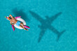 © New Africa - Happy man with inflatable ring in swimming pool, top view. Flying airplane casting shadow on water