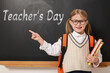 © New Africa - Happy Teacher's Day. Cute little girl with eyeglasses near blackboard