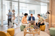 © Santi Nuñez/Stocksy - Business team collaborating on project in modern office