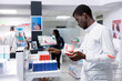© DC Studio - Pharmacy retail scene showing a customer searching for over the counter medicine, health products for cardiology care on shelves. Focusing on self care with cardio medicine at dispensary.