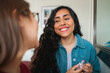 © Dani Nahuel/Stocksy - Latina Woman Smiling While Chatting with Her Friend