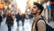 © walira - A young man with dark curly hair and a backpack looks upward in a blurry street scene. Warm sunlight bathes the crowd