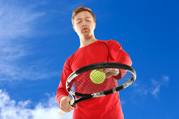 Wall Mural - man playing tennis against blue sky with clouds, low angle view