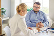 © Studio Romantic - Doctor and patient during obesity consultation support. The physician writes notes as the fat overweight man listens during medical exam in clinic. Collaborative medical weight management