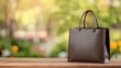 © Preecha - A brown leather shopping bag on a wooden plank, warm studio tones, copy space above, commercial vibe.