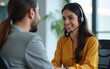 © bai - Young indian or araian arab female financial specialist holding video call with clients partners online in office. Latin Hispanic woman wearing headset helping as callcenter consult operator. Vertical