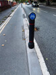 Bicycle lane bollard standing on a road in Manchester, UK during evening