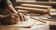 © Aksaka - Hands drawing woodworking plans with pencil on paper