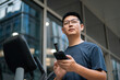 © zhu difeng - man in a gym using his phone