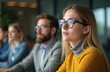 © Pete - Young woman attentively listens to presentation in modern conference room. Corporate meeting audience engaged in discussion, learning, networking, innovation. Teamwork, collaboration, communication