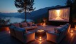 © Pete - Luxury outdoor cinema setup features plush sofas, fire pit table with popcorn, large projector screen displaying forest road. Scene set at dusk overlooking tranquil lake, mountains, with ambient