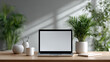 © Andrew - Workspace Serenity: A modern laptop sits amidst an inviting indoor scene with a bright, blank screen, a blend of technology and nature's touch. A serene, comfortable, and productive workspace.