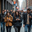 © Pete - Group of people walk on city street engrossed in smartphones. Men and women look down at mobile devices, ignoring surroundings. Urban lifestyle, modern communication, digital distraction theme.