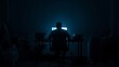 © Deski - A Person's Silhouette in a Dark Room Lit by a Bright Screen