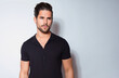© Anetta - Handsome young man with dark hair and beard posing in casual clothes